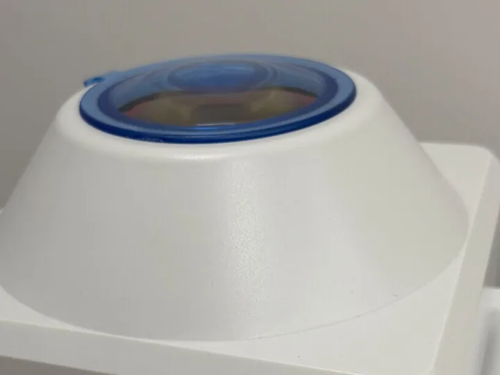 A benchtop centrifuge with two controls and a blue lid.